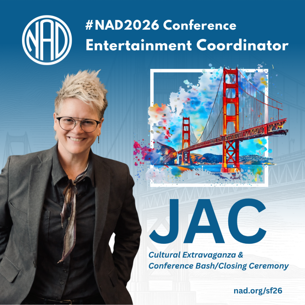 Person with short hair and glasses wearing a dark suit, standing in front of a blue background with text about the NAD2026 Conference and a colorful illustration of the Golden Gate Bridge.